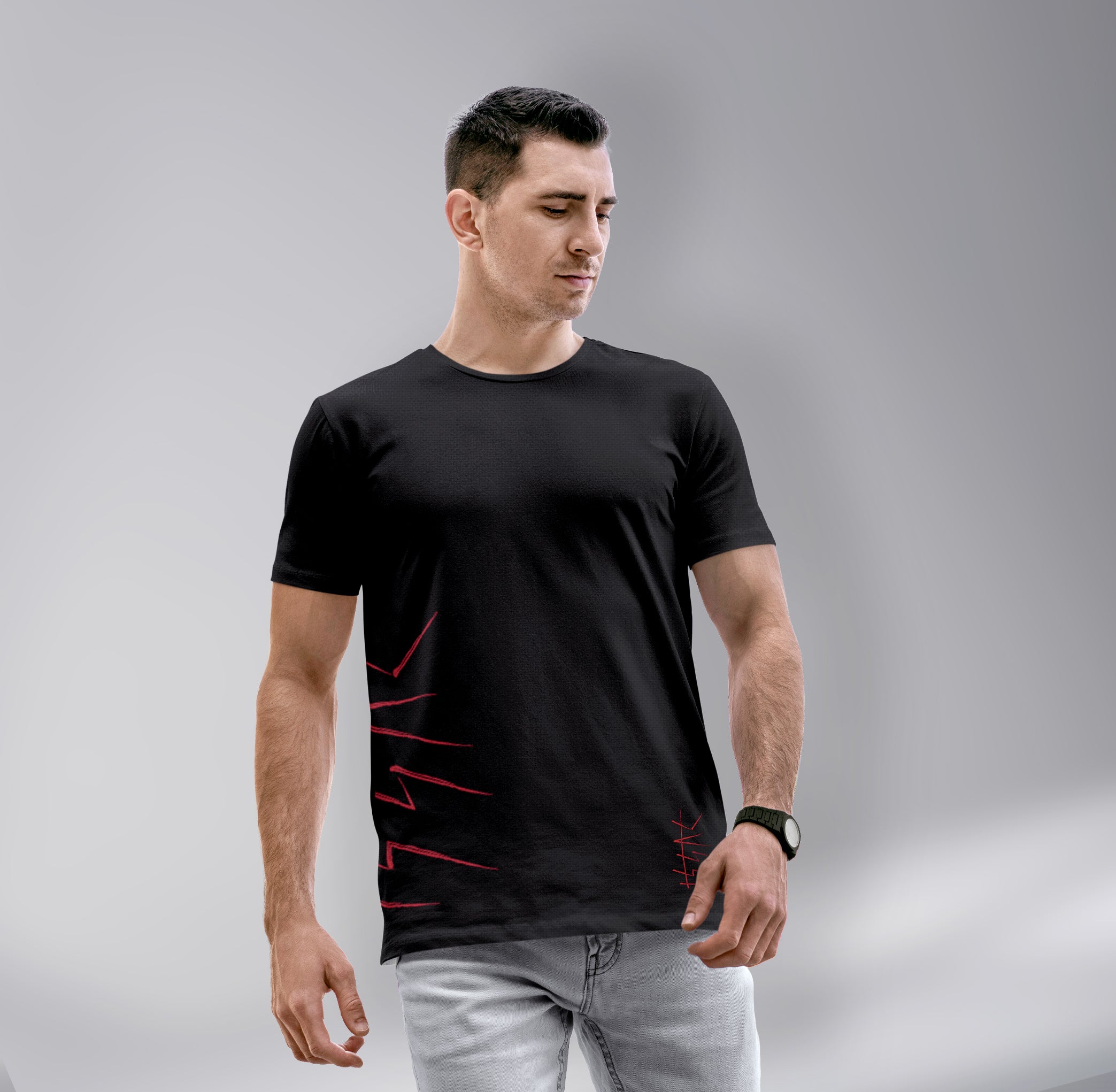 Man wearing a black t-shirt with red designs on a gray background