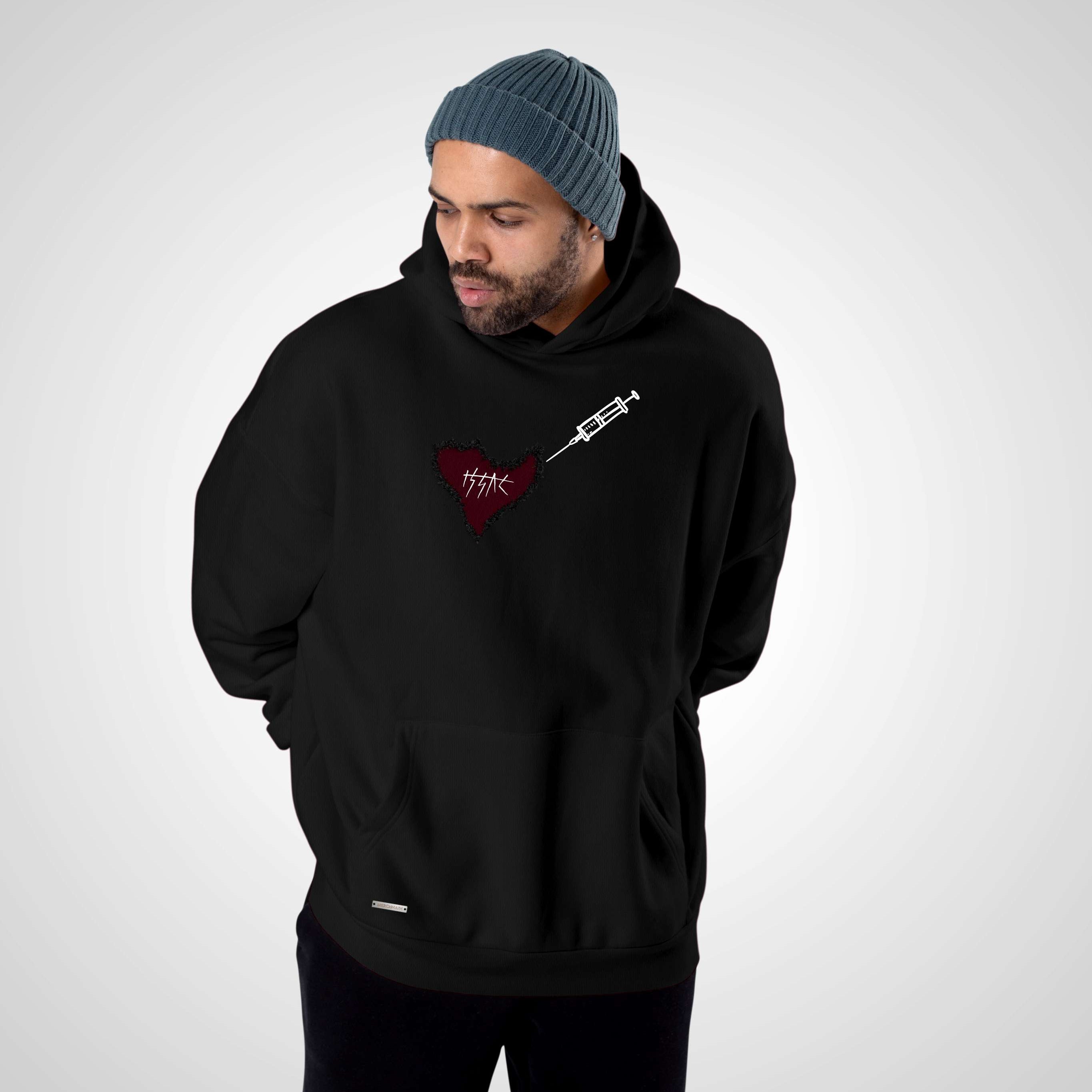 Man wearing a black hoodie with a logo on a gray background
