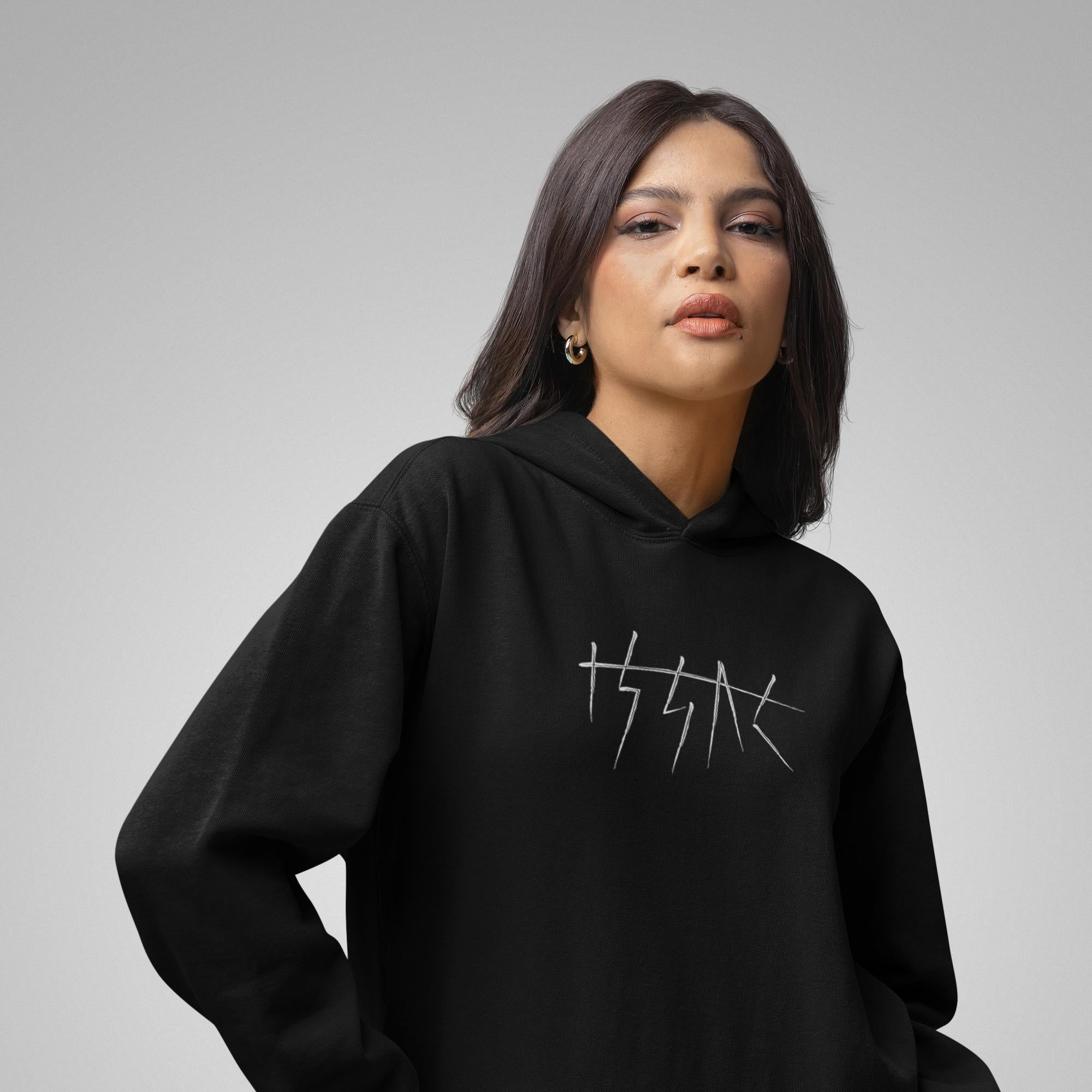Woman wearing a black hoodie with a logo on a gray background