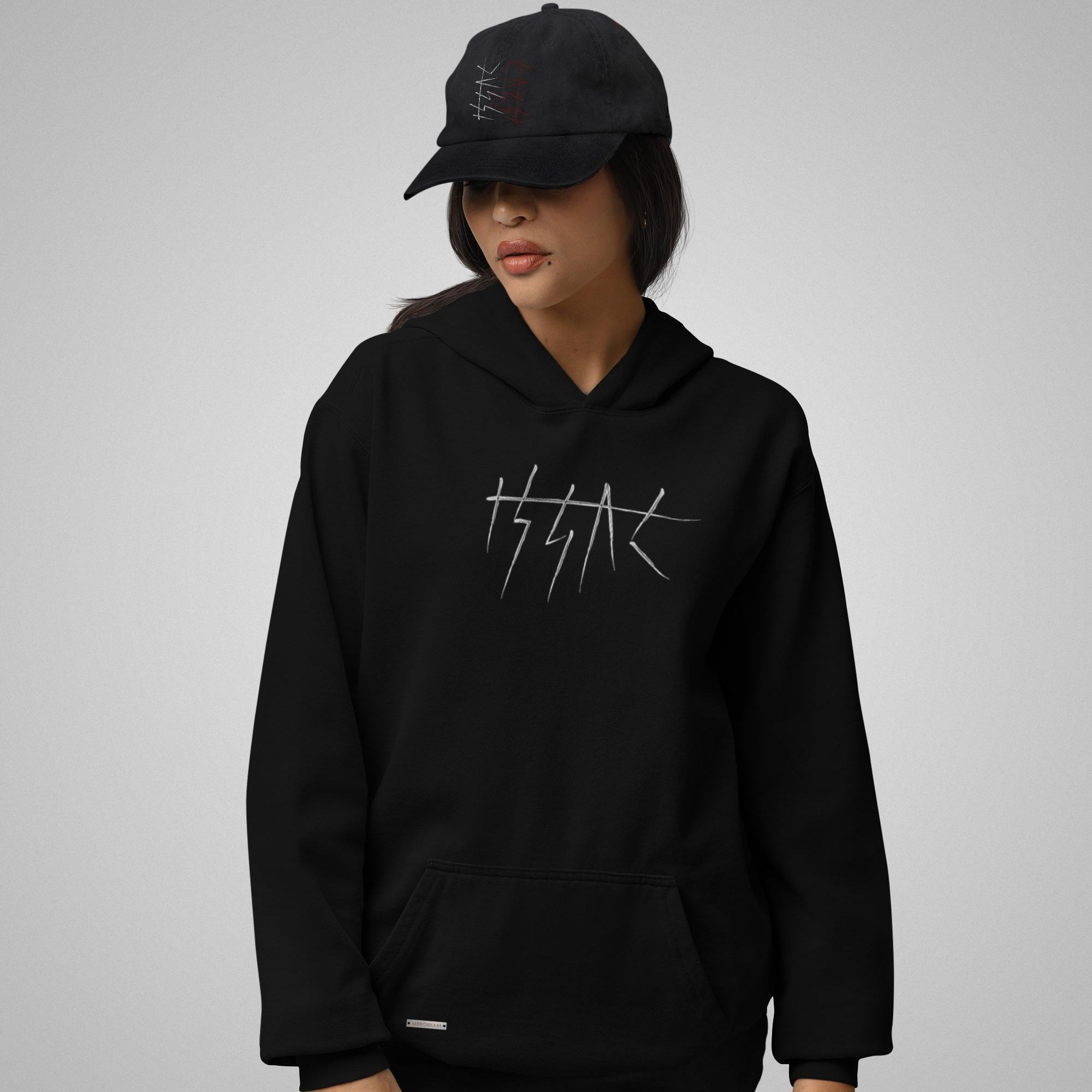 Person wearing a black hoodie and cap with a logo on a gray background