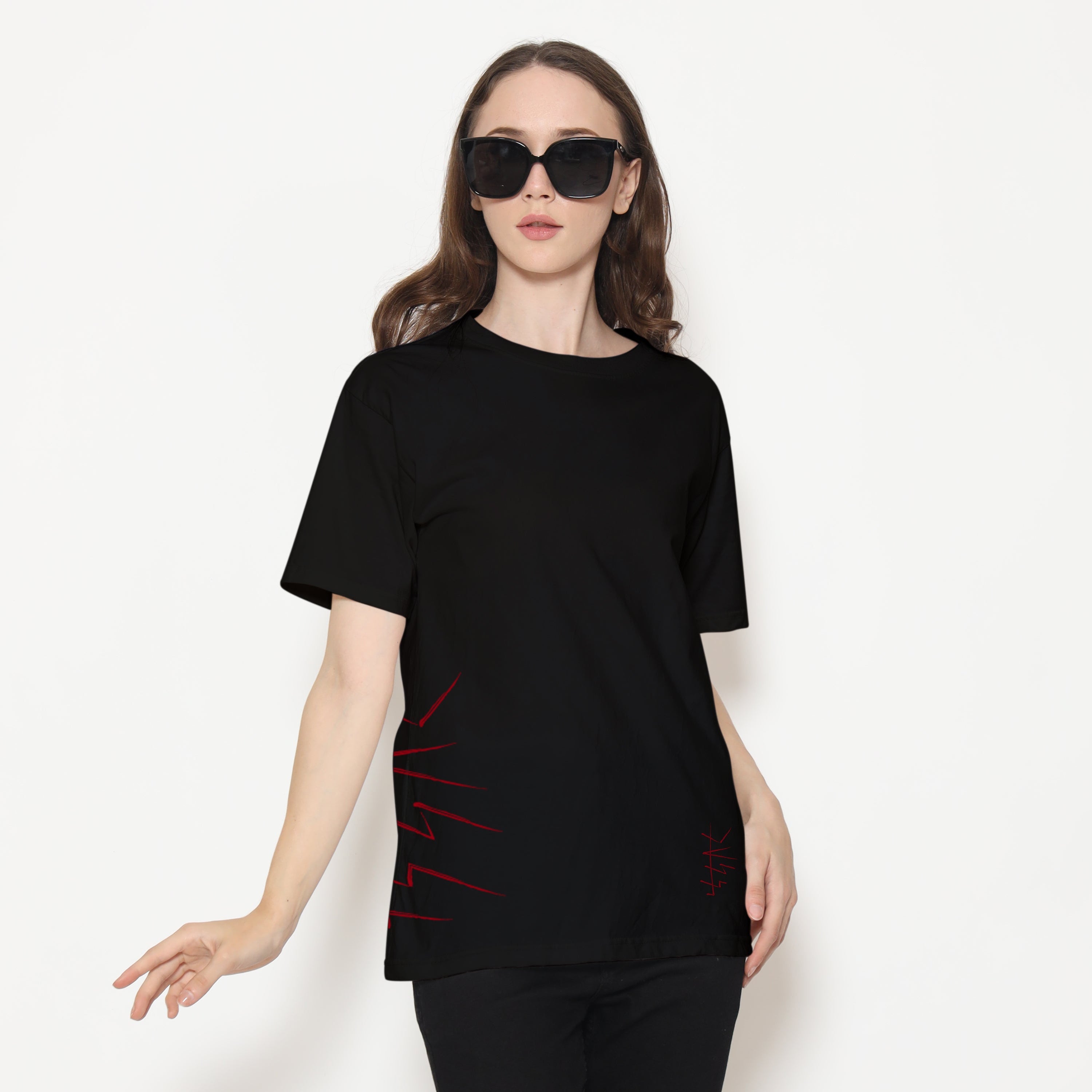 Woman wearing a black t-shirt with red design on a white background